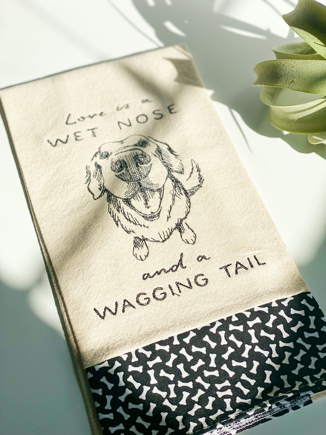 Love is a wet nose and a wagging tail Tea Towel